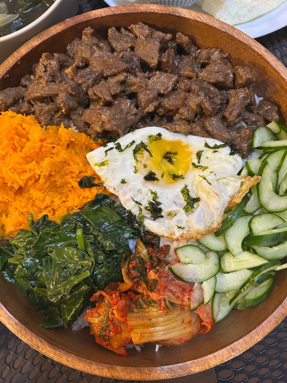 delicious korean bibimbap in wooden bowl